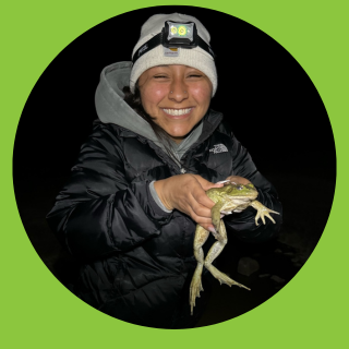 Student holding a frog