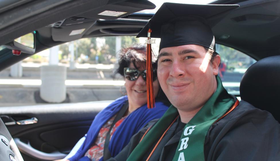 Ventura College Graduate sitting in their car during the drive-thru event.